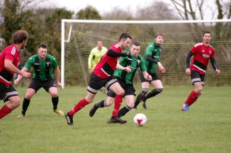 Clarby Roads Matthew Ellis is closely tracked by Goodwick United